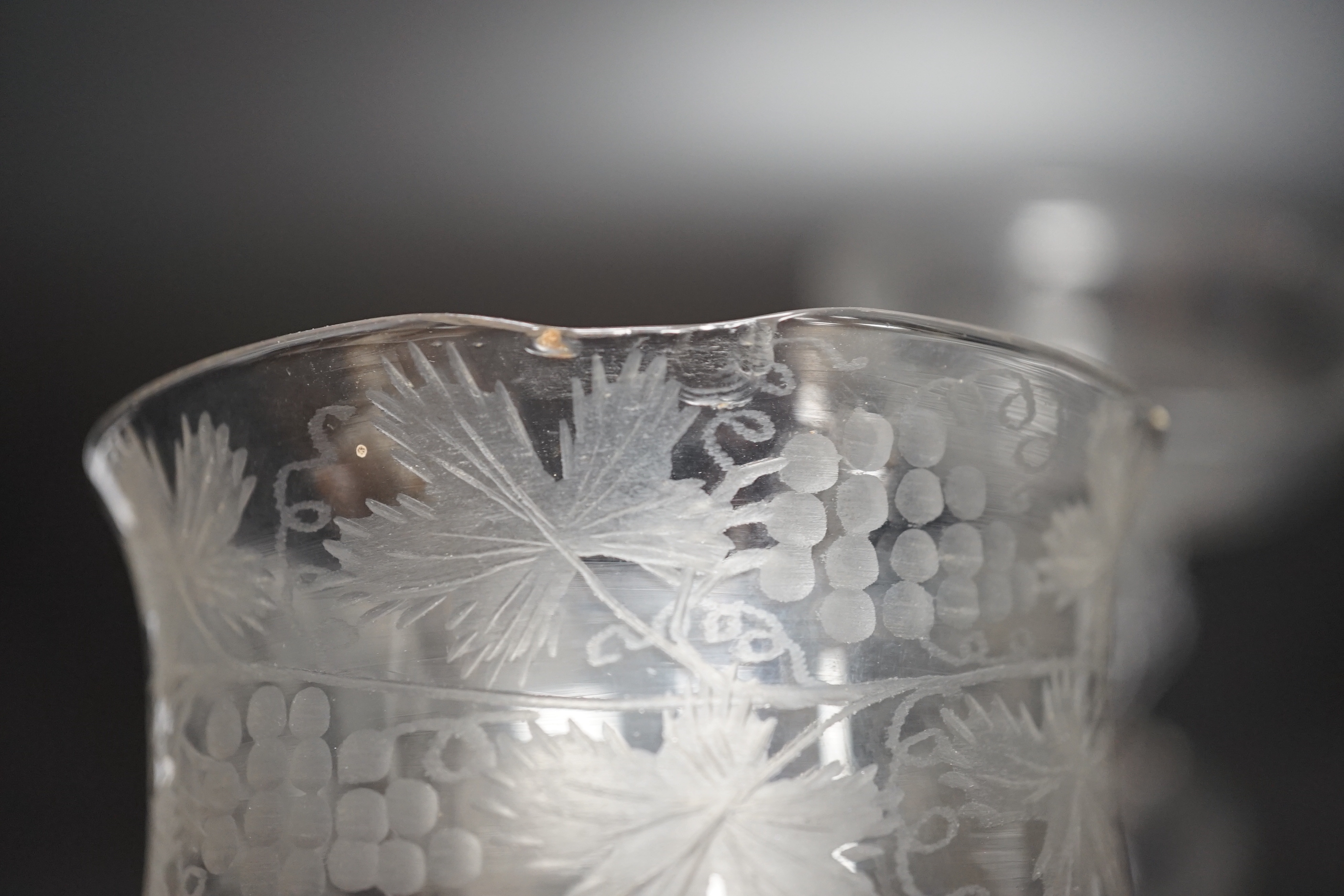 Two champagne or sweetmeat glasses c.1740, with double ogee bowls, the taller example with etched vines around bowl and plain stem, the shorter example with collar under the bowl, over an eight sided moulded pedestal ste